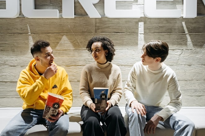 Friends talking outside a movie theater. - get to know you