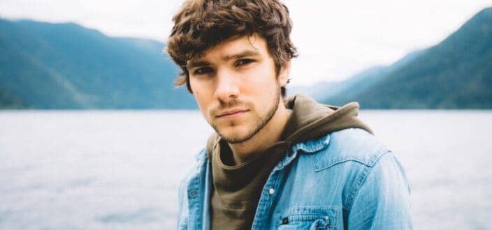 guy in denim overlooking nature