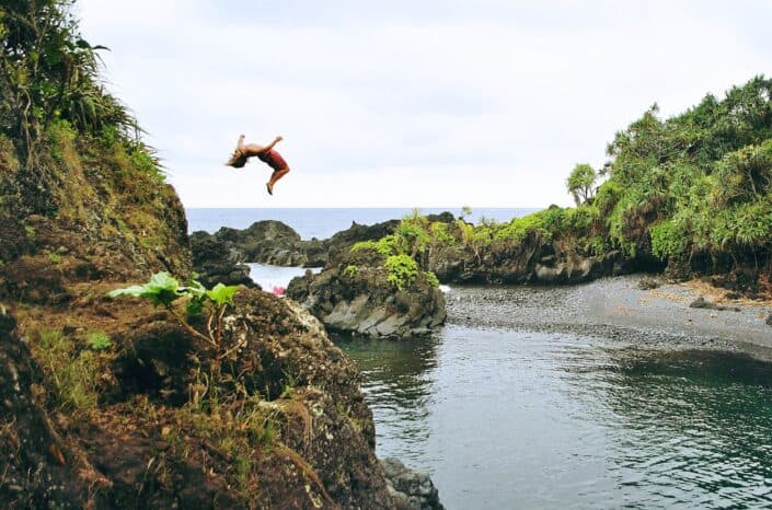 Man back-flipping from a cliff