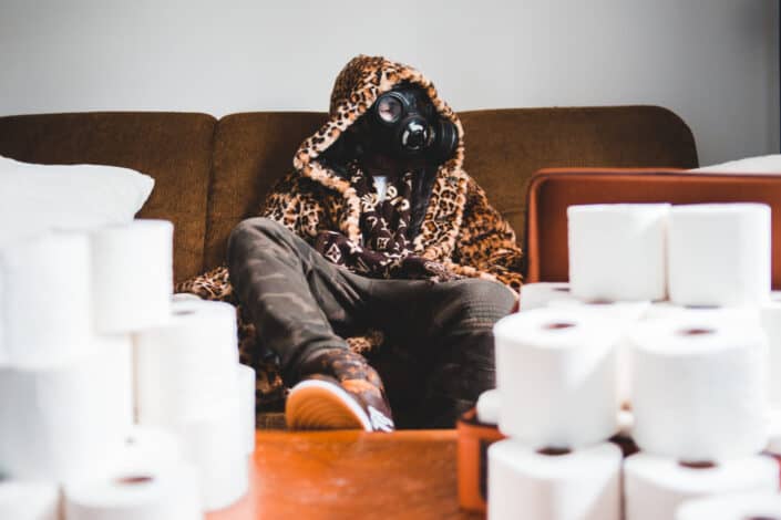 Masked-man sitting on a sofa