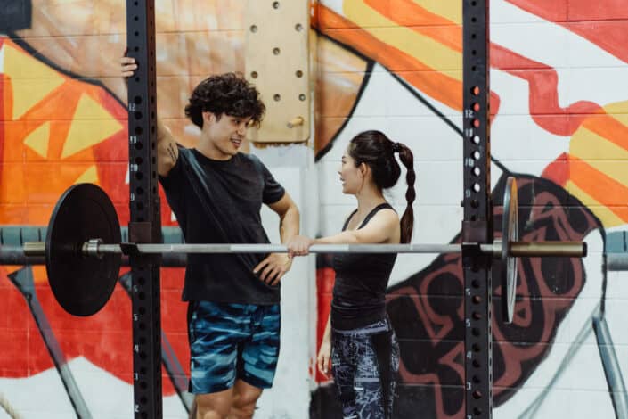 A Fit Couple Talking while in the Gym