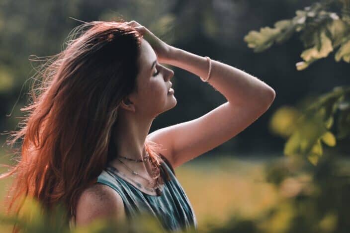 Woman behind the trees.