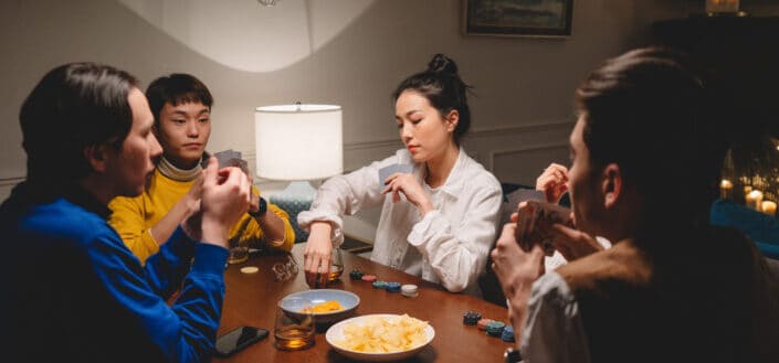 friends chilling out by playing cards