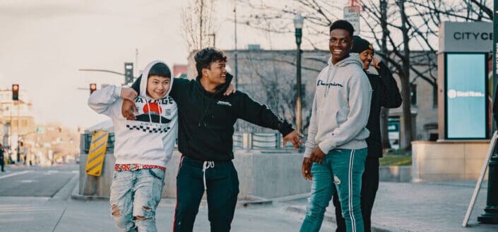 Multiethnic friends resting on street