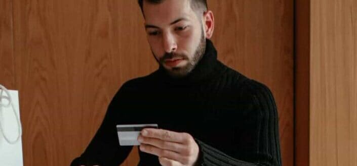 confident young man doing online shopping at home