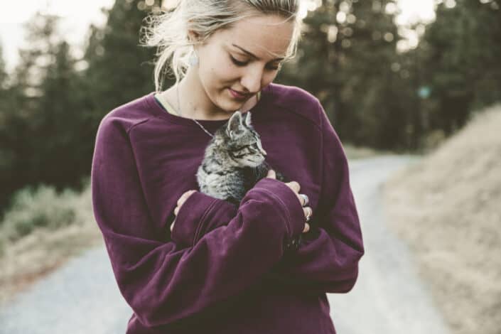 Woman carrying her kitten