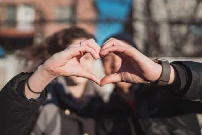 two person combine hand forming a heart hand gesture