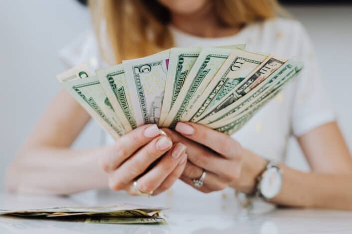 Woman holding dollar bills