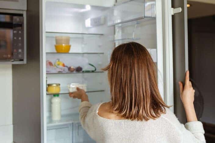 Woman in White Sweater in Refrigerator