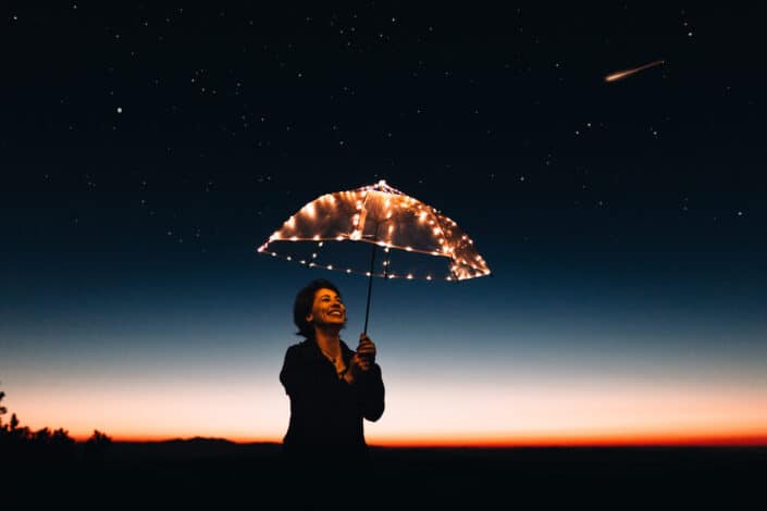 Cheerful woman posing with her umbrella