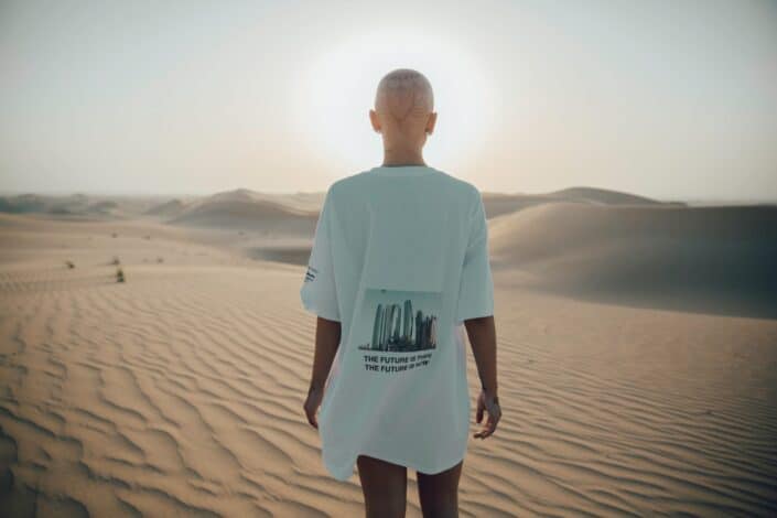 Bald person walking thru the desert sands