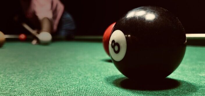 Billiard ball number eight being targeted.