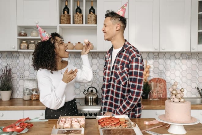 Woman in White Long Sleeve and Man in Checkered Long Sleeve Eating Dessert - Fun things to do on your birthday