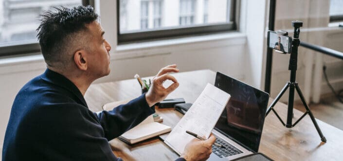 Man explaining while sitting on his desk