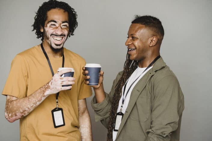 colleagues having fun while holding coffee