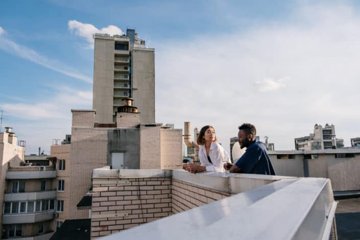 man and woman standing at the rooftop