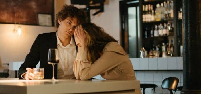 man comforting the girl in a restaurant