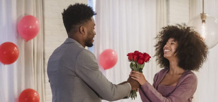 Man giving her girl red roses