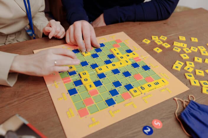 Couple playing scrabble together.