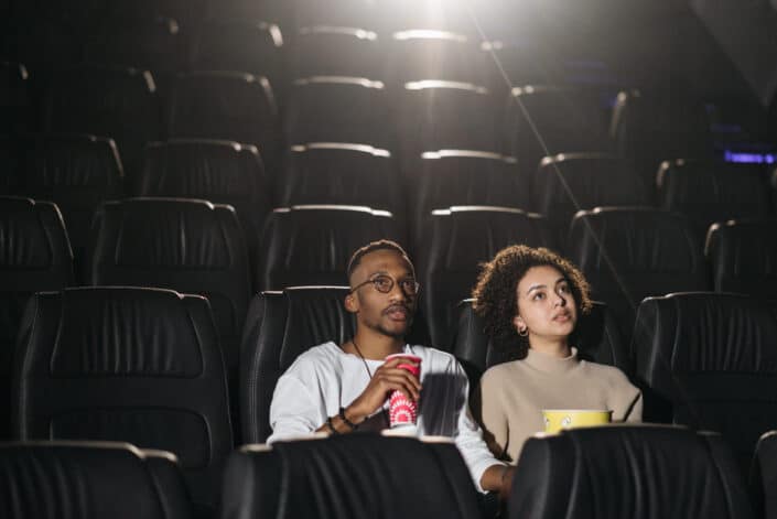 Couple watching a movie in a theater.