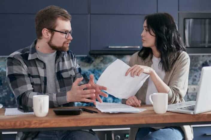 Man giving a document to his woman.