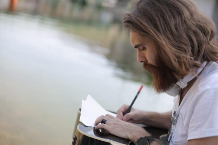 Man writing by the river