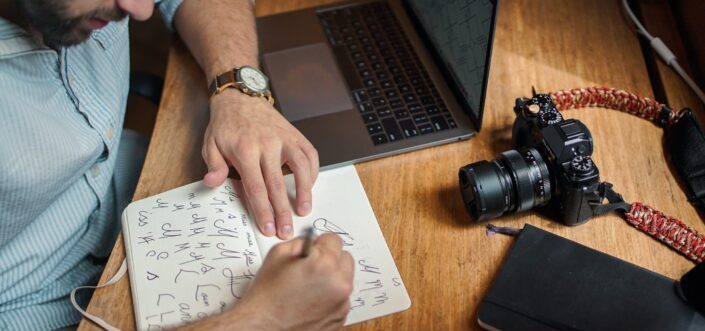 Man writing on his sketch pad.