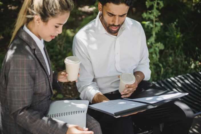 colleagues talking while Holding Disposable Cups