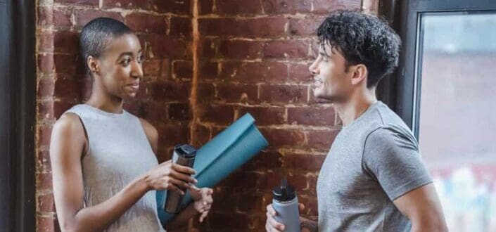 Sporty multiracial couple having conversation