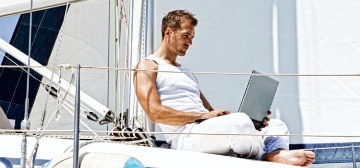 man with the laptop computer in yacht