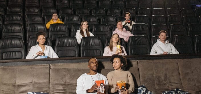 People inside a theatre watching a movie.