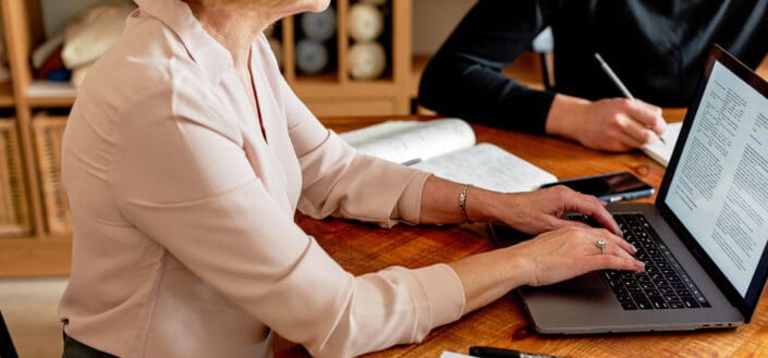 Woman in a formal long sleeve working on her computer