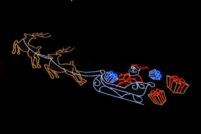 Santa riding his sleigh throwing gifts