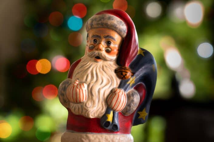 santa figurine carrying a bag with presents