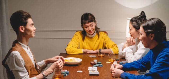 friends playing poker while drinking
