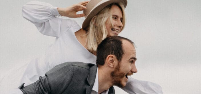 Man and woman beautifully smiling while striking an awkward pose 