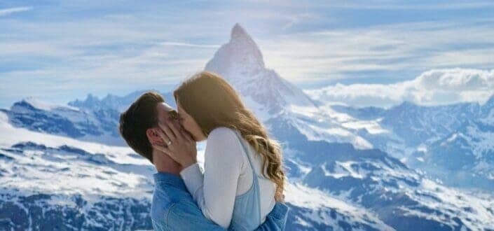 Man and woman kissing on the mountains