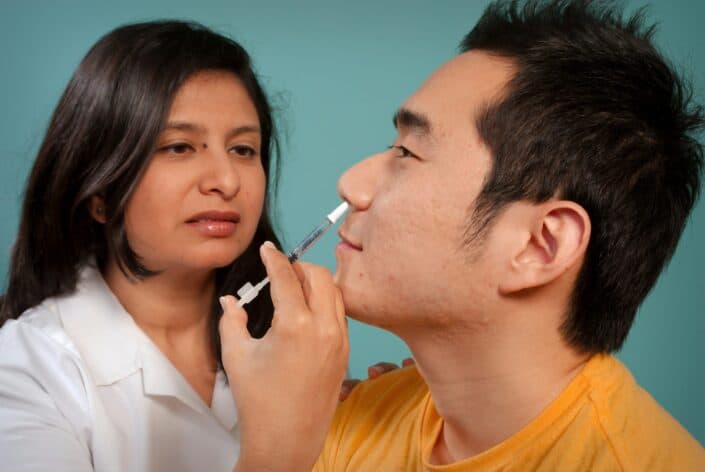 doctor attending to her male patient