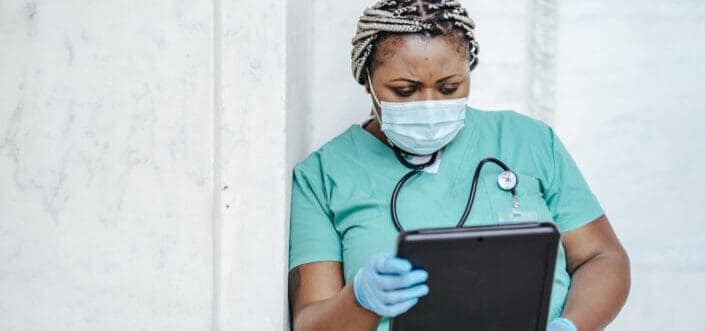 medical personel reading a write up in a clipboard
