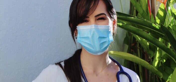 A medic wearing a mask smiling