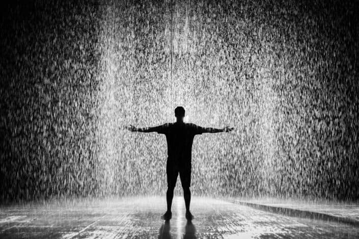 silhouette of man outside under the rain