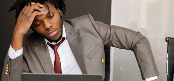 man looking problematically at his laptop