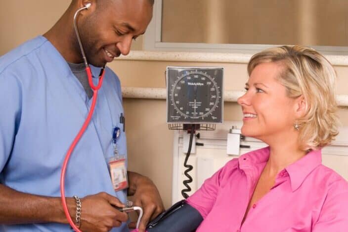 man checking blood pressure of a patient
