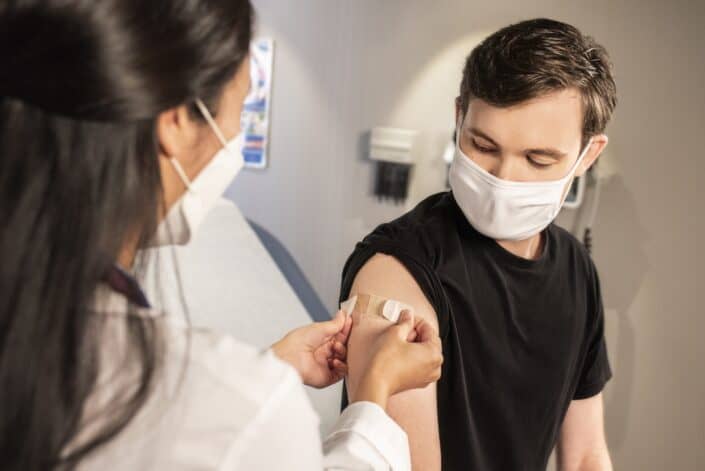 Man vaccinated by a medical personnel