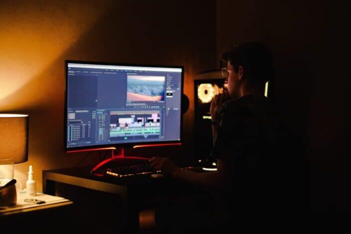 A young guy busy editing on his computer