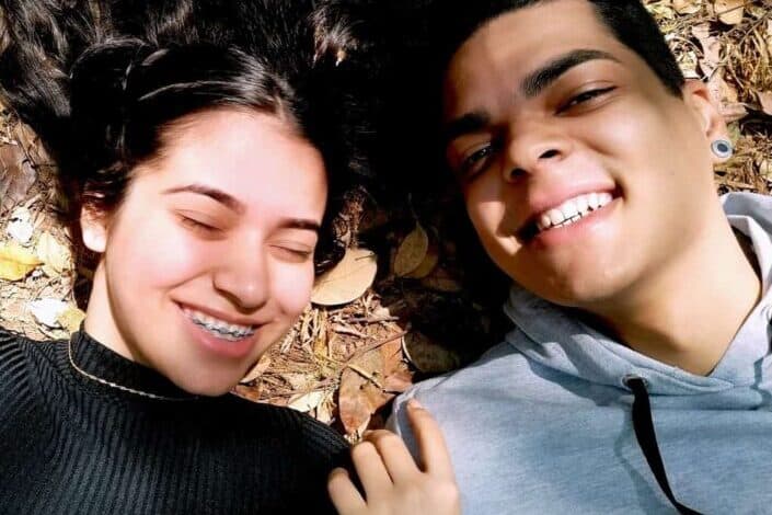 multiracial couple lying on brown leaves