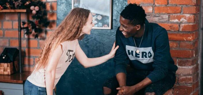 couple laughing near wall