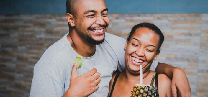 couple enjoying their pineapple drinks