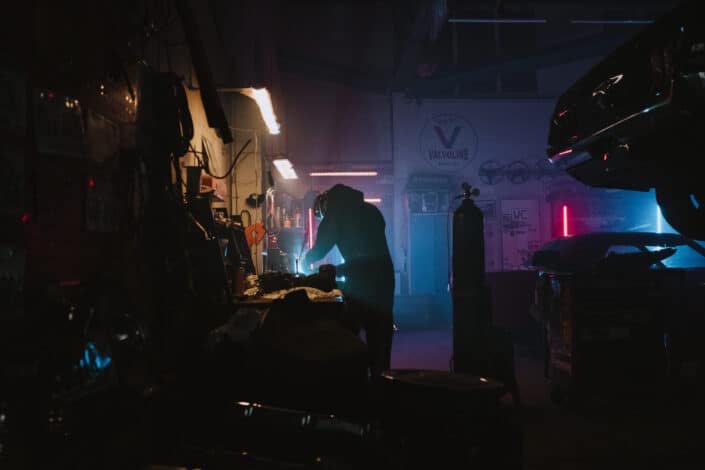 A technician busy working on stuff on his dark workplace