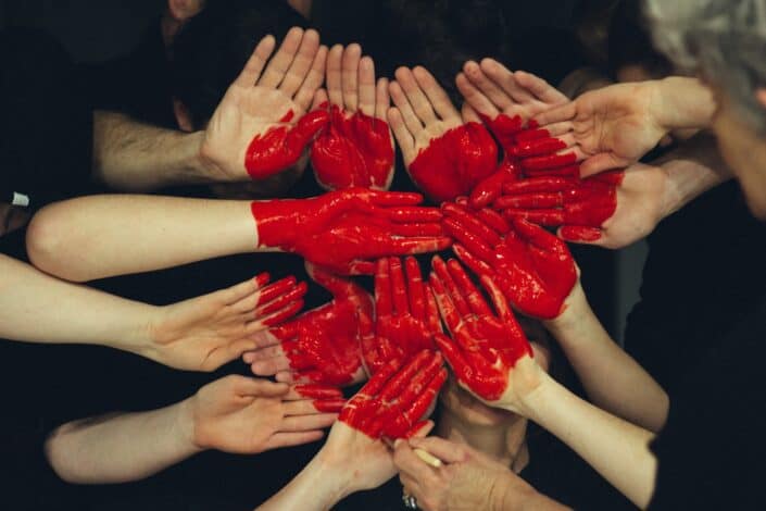 A heart formed by variety of hands.